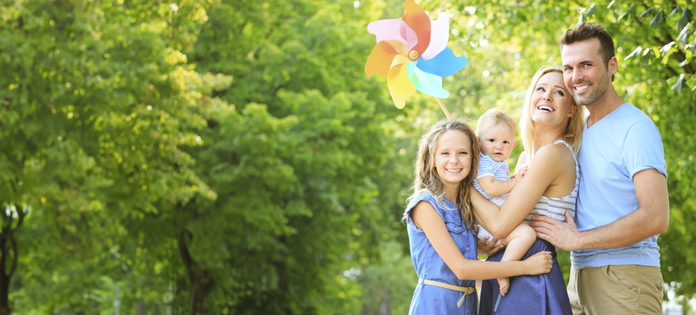 Family of four smiling outdoors after visiting pediatric dentist in Dublin