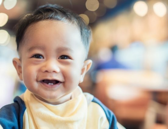 Smiling toddler in yellow shirt