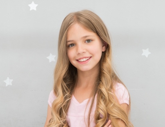 Young girl in pink tee shirt smiling