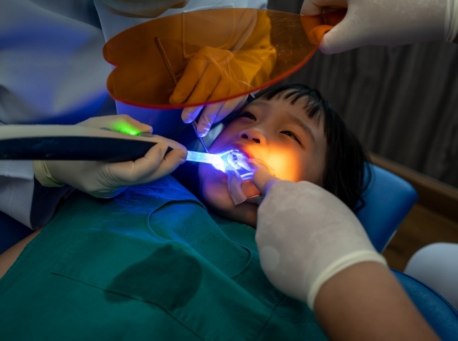 Child receiving a dental treatment