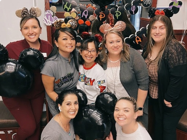 Pediatric dental team members all wearing Mickey Mouse ears