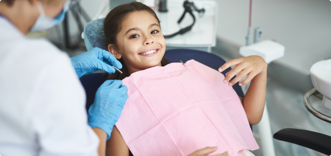 Young girl smiling while visiting pediatric dentist in Dublin