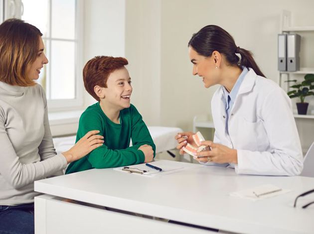 Mother and son talking to dentist