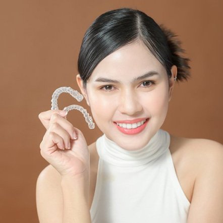 Pleased teen shows off Invisalign trays