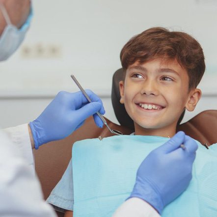 Kid smiles at dentist