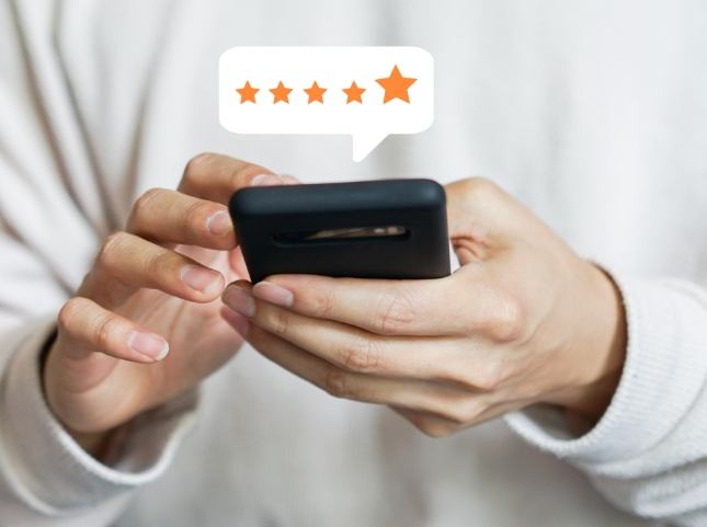 Person leaving a five star review on their phone