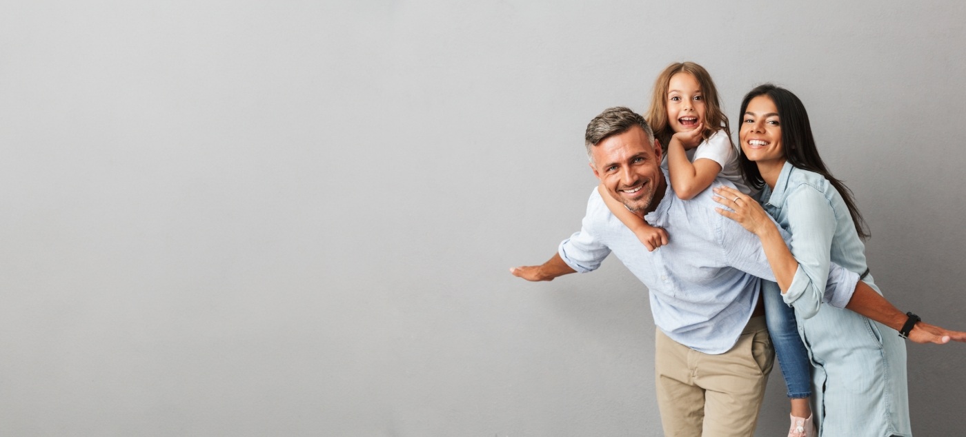 Young girl smiling with her parents after visiting sedation dentist for kids in Dublin