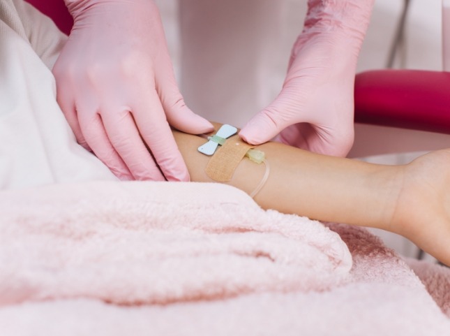 Person adjusting I V on a patients arm