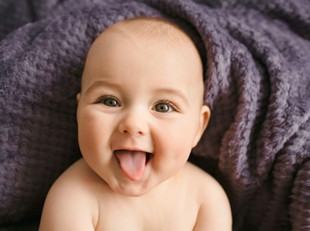 Happy baby sticking their tongue out