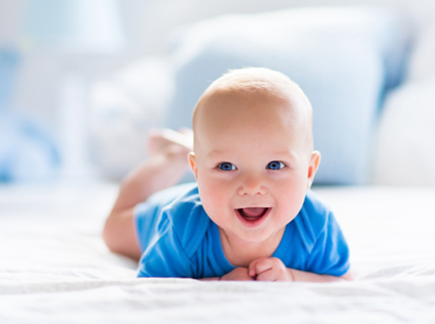 Happy baby enjoying tummy time